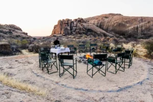Chairs set out for sundowners among the granite koppies