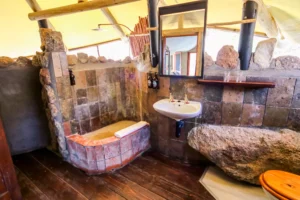 Stone-walled bathroom built around the granite rock