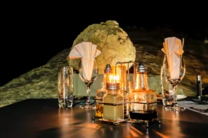 Lanterns and glasses on a dinner table at night