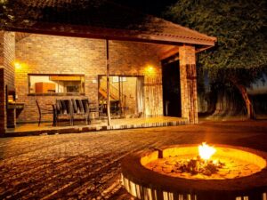 Chalet patio and fire pit lit up at night