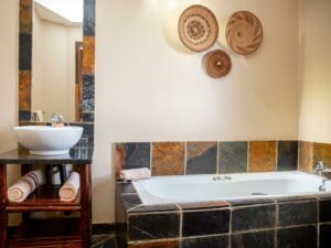 Bathroom with a slate bath and woven basket decor