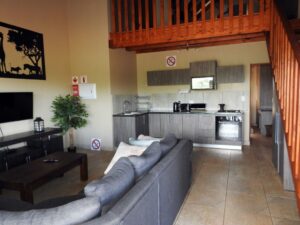 Open-plan lounge and kitchen with a loft