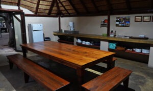 Open-plan kitchen with a long wooden dining table