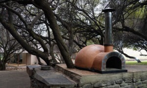 Outdoor pizza oven beside the fire area