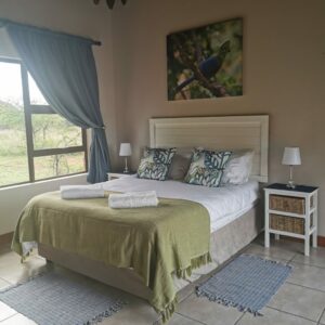 Double bedroom with a bird painting above the bed