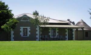 Lodge building with a veranda across a green lawn