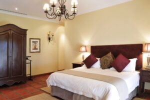 Double bedroom with a chandelier and antique wardrobe