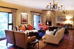 Lodge lounge with a stone fireplace and leather chairs