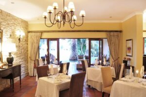Lodge dining room set for dinner under chandeliers