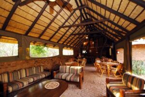 Thatched lounge and dining area with safari-style furniture